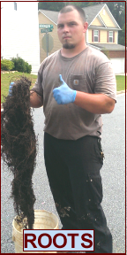 Man in Woodstock, Ga removing tree roots from sewer.